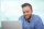 Cheerful bearded Caucasian man using laptop or businessman working in office